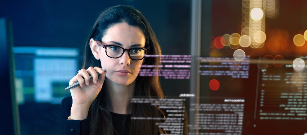 Data Entry Operator Imagery - Image of a woman looking at a screen with a pen in her hand
